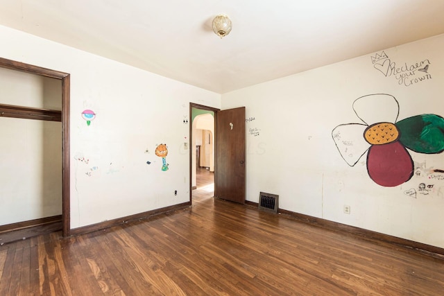 unfurnished bedroom with dark hardwood / wood-style floors