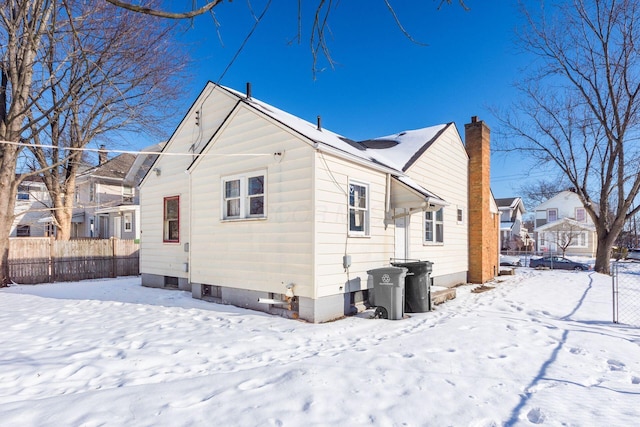 view of snow covered rear of property