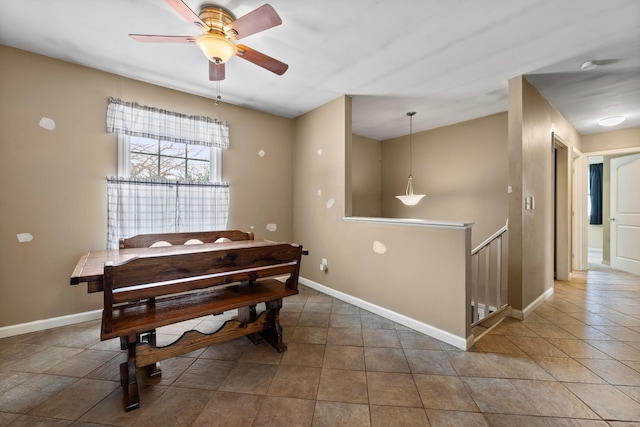 tiled dining area with ceiling fan