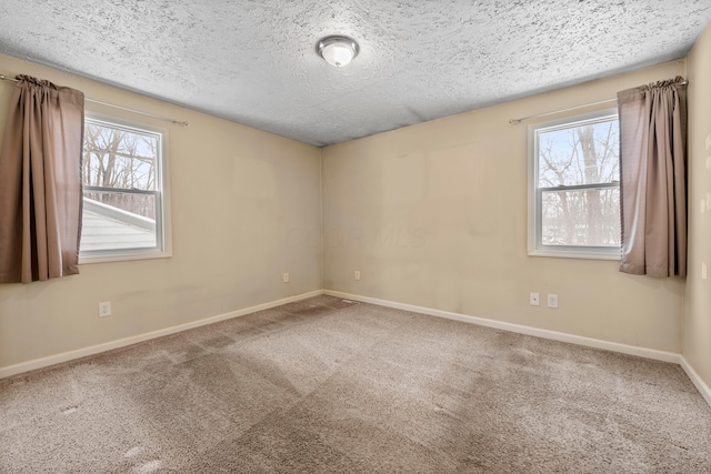 unfurnished room with a textured ceiling and carpet floors