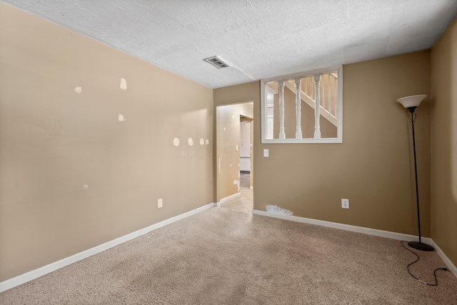 unfurnished room featuring a textured ceiling