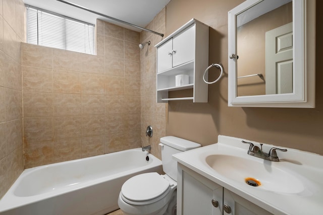 full bathroom with toilet, vanity, and tiled shower / bath