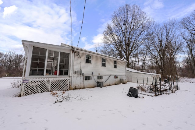 view of snow covered rear of property