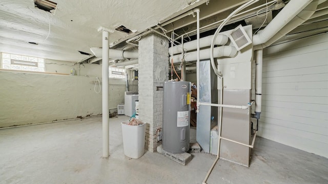 basement featuring washer / dryer, plenty of natural light, visible vents, and electric water heater