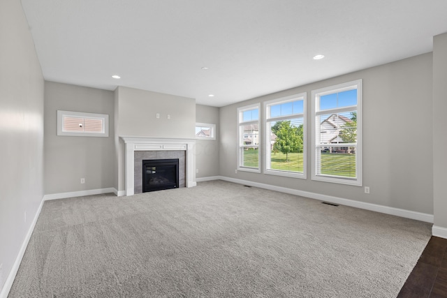 7136 Cabernet Ct, Dublin, OH 43016 - unfurnished living room with a tiled fireplace, recessed lighting, and wood finished floors