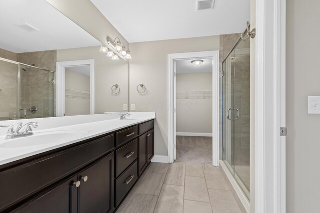 7136 Cabernet Ct, Dublin, OH 43016 - full bathroom featuring a spacious closet, double vanity, a shower stall, and tile patterned flooring