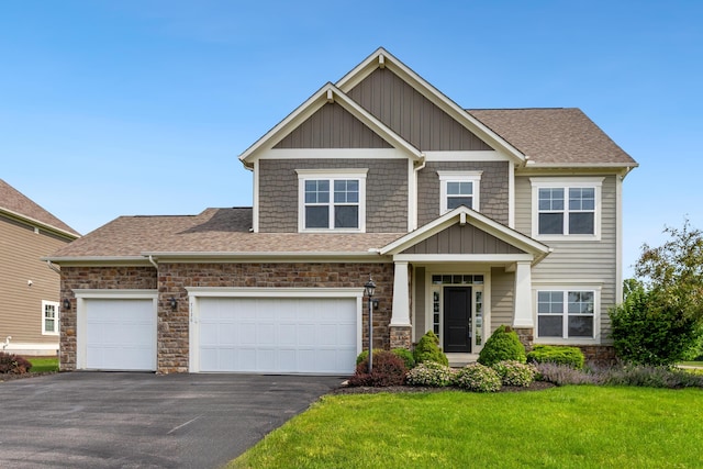7136 Cabernet Ct, Dublin, OH 43016 - craftsman-style home with asphalt driveway, a front yard, stone siding, roof with shingles, and an attached garage