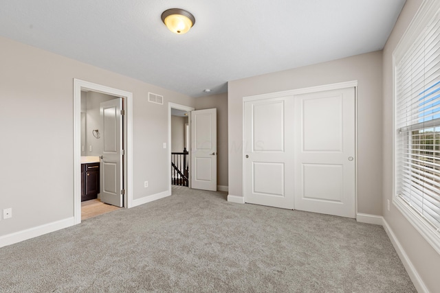 7136 Cabernet Ct, Dublin, OH 43016 - unfurnished bedroom with light carpet, a closet, and connected bathroom
