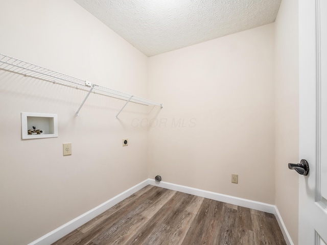 laundry room with hookup for an electric dryer, hardwood / wood-style flooring, hookup for a washing machine, and a textured ceiling