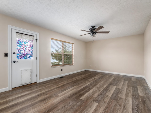 entrance foyer with ceiling fan, dark wood-type flooring, and a textured ceiling