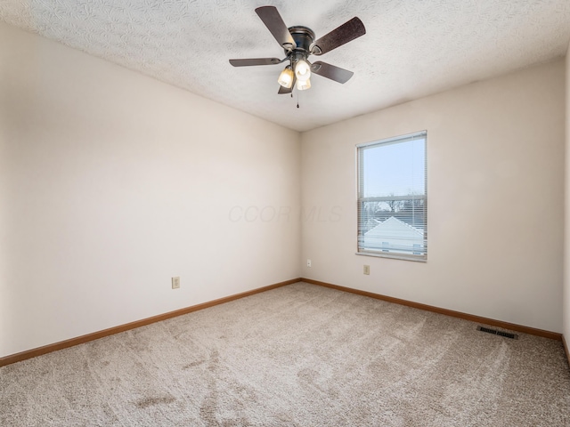 unfurnished room with ceiling fan, a textured ceiling, and carpet flooring