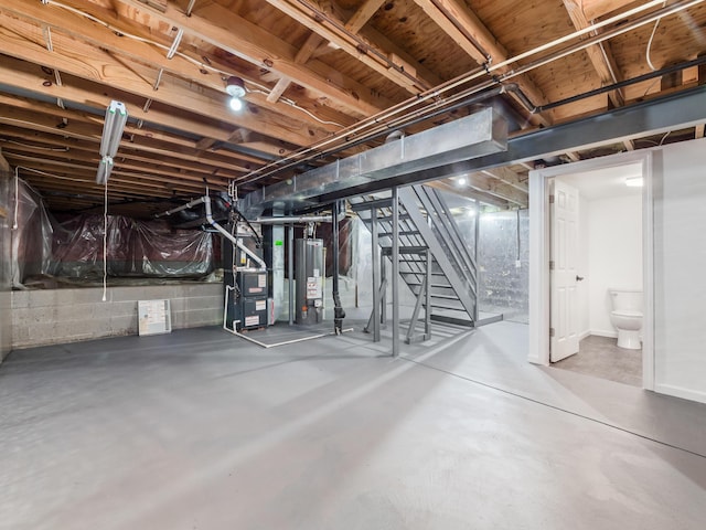 basement featuring heating unit and water heater