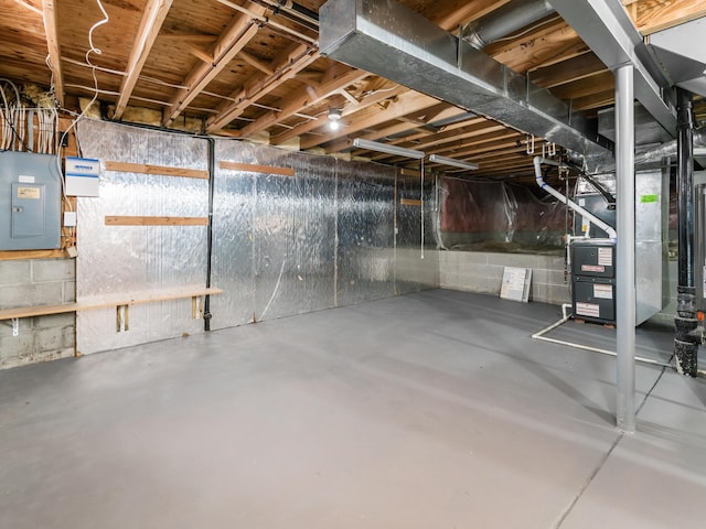 basement with electric panel and heating unit