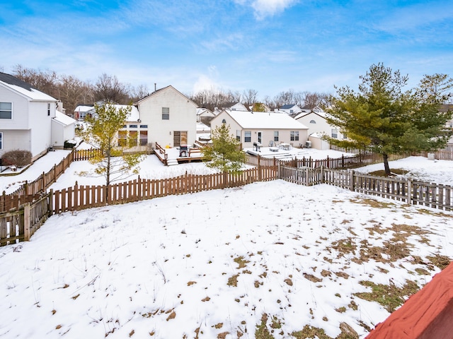 yard layered in snow with a deck