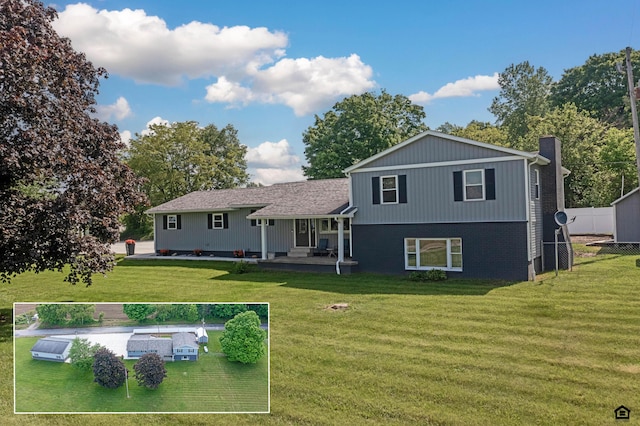 rear view of house with a yard