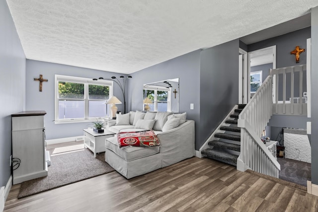 living room with a textured ceiling and hardwood / wood-style flooring