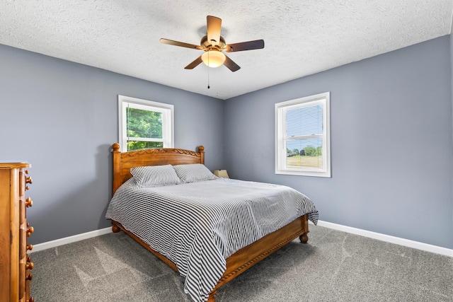 carpeted bedroom with a textured ceiling and ceiling fan