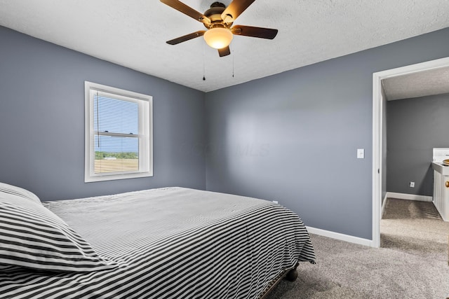 carpeted bedroom with ceiling fan and a textured ceiling