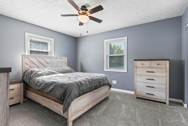 bedroom with dark carpet, a textured ceiling, and ceiling fan