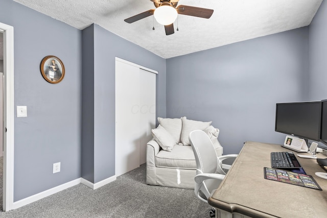 office space with carpet floors, ceiling fan, and a textured ceiling