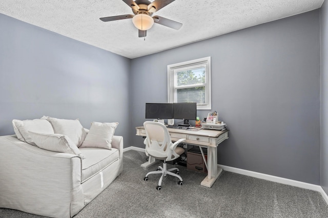 carpeted office space with a textured ceiling and ceiling fan