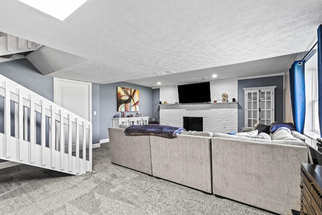 carpeted living room with a textured ceiling and a fireplace