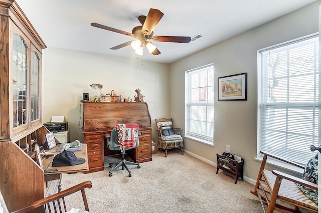 carpeted office space with ceiling fan