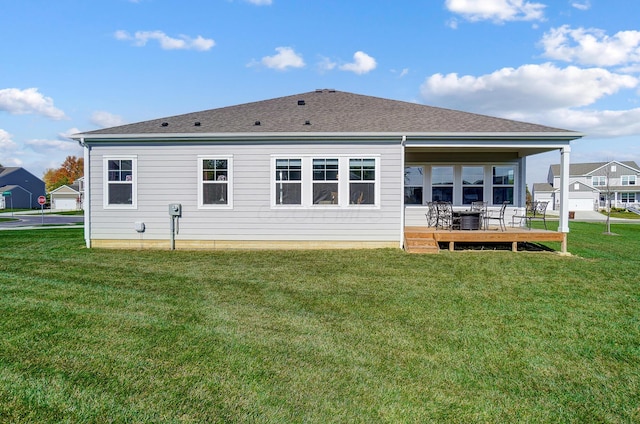 rear view of property with a yard