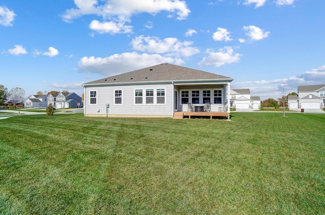 back of property featuring a yard and a wooden deck