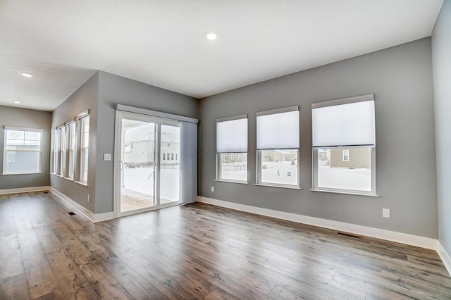 spare room with wood-type flooring