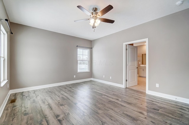 empty room featuring ceiling fan and light hardwood / wood-style flooring