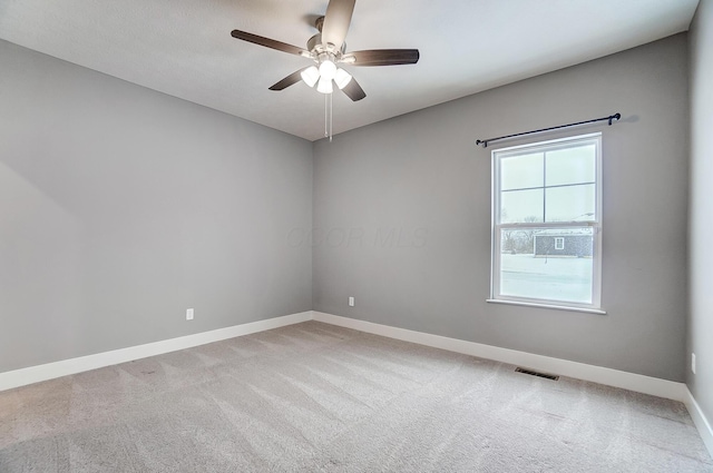 empty room with carpet flooring and ceiling fan