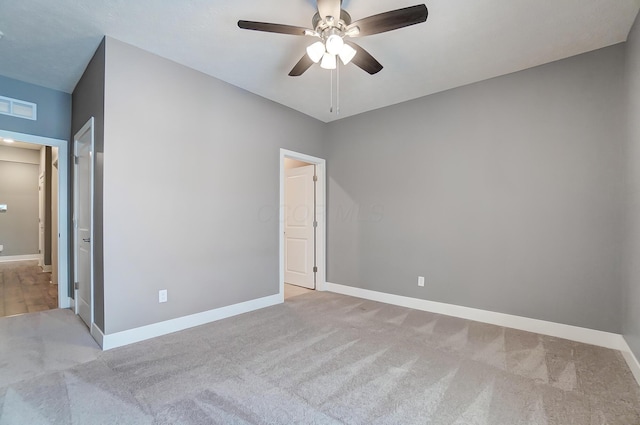 unfurnished bedroom featuring light colored carpet and ceiling fan