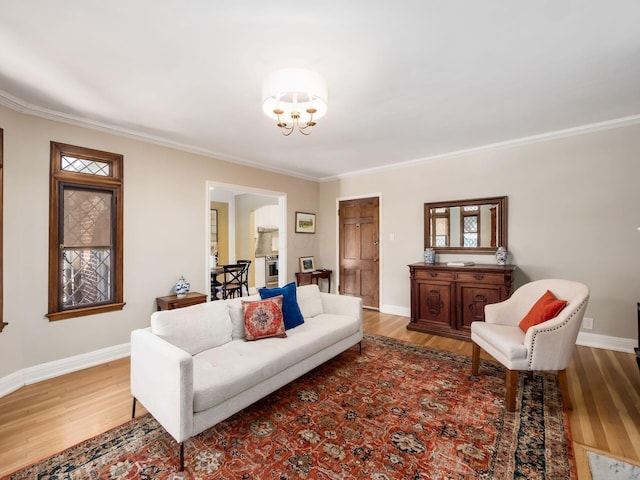 living room with ornamental molding, a chandelier, and hardwood / wood-style flooring