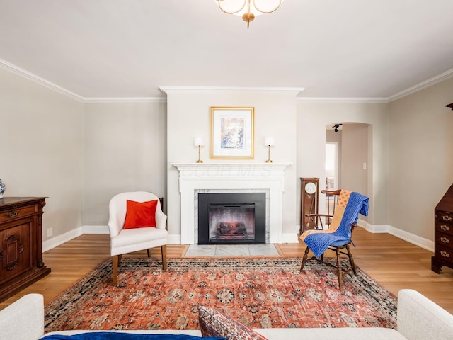 living room featuring crown molding and light hardwood / wood-style flooring