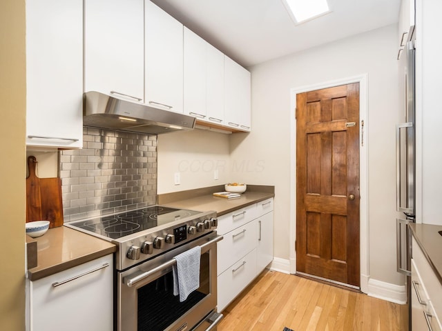 kitchen featuring white cabinetry, backsplash, electric range, and light hardwood / wood-style flooring