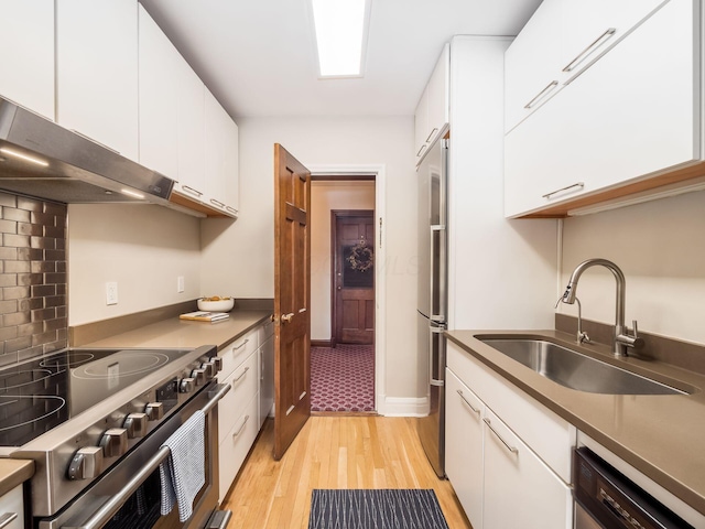 kitchen with sink, stainless steel appliances, and white cabinetry