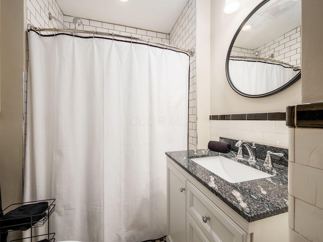 bathroom with tile walls and vanity