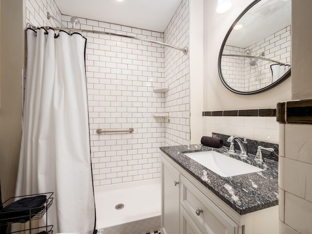 bathroom with curtained shower, tile walls, and vanity