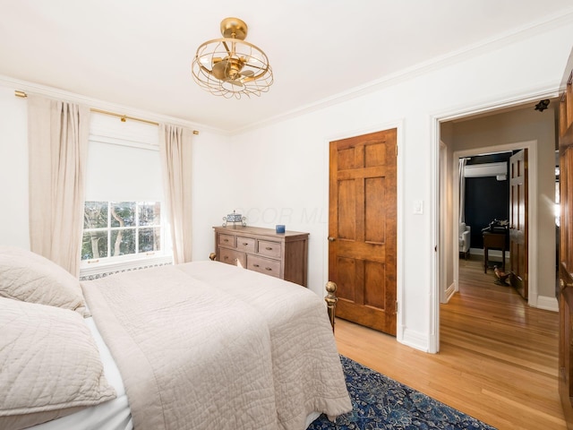 bedroom featuring light hardwood / wood-style floors and ornamental molding