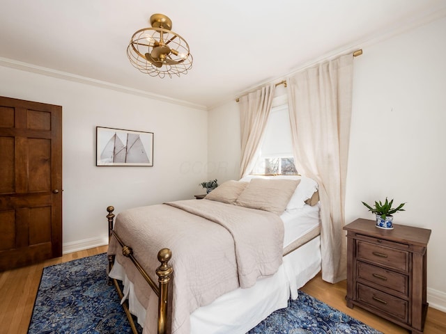 bedroom featuring hardwood / wood-style flooring and ornamental molding