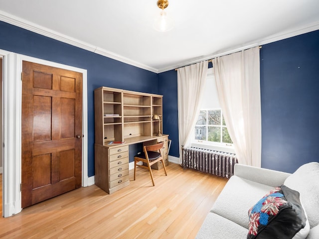 office area with ornamental molding, hardwood / wood-style floors, and radiator heating unit