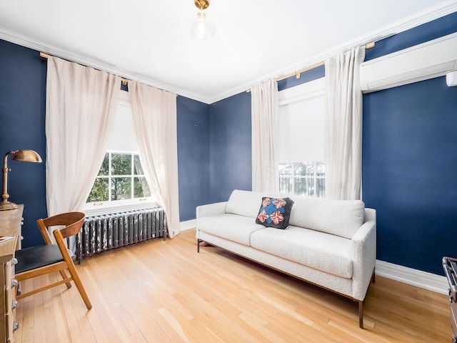 sitting room featuring crown molding, a wall mounted AC, radiator heating unit, and hardwood / wood-style floors