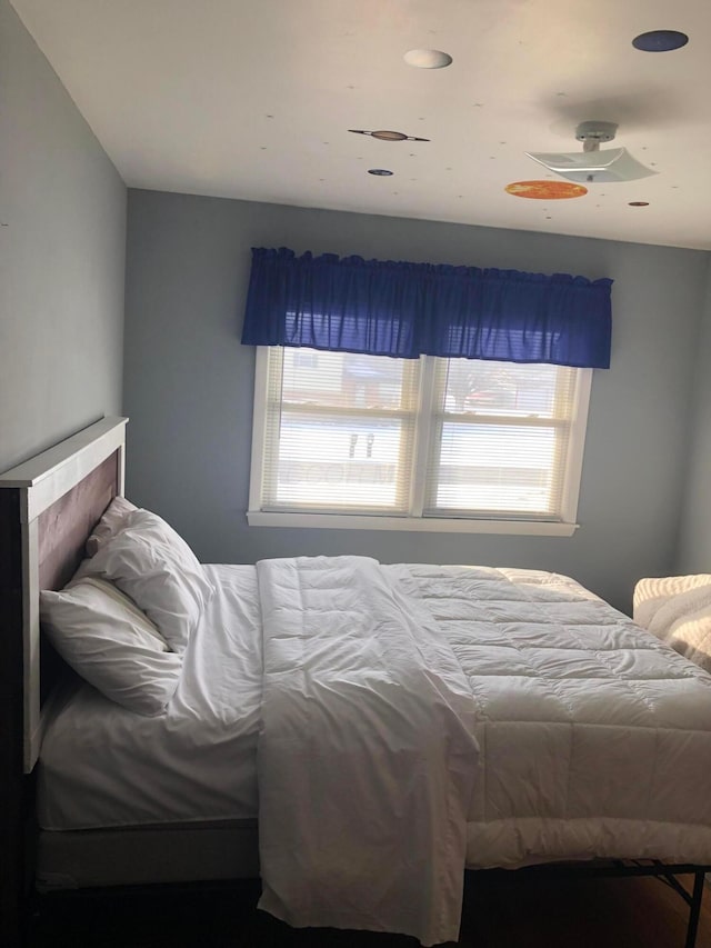 bedroom featuring ceiling fan and multiple windows