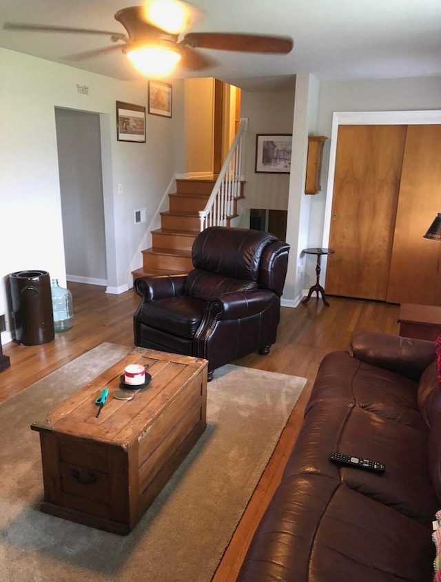 living room featuring ceiling fan and wood-type flooring