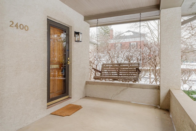 view of snow covered property entrance