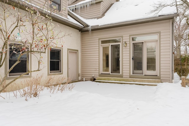 view of snow covered property entrance