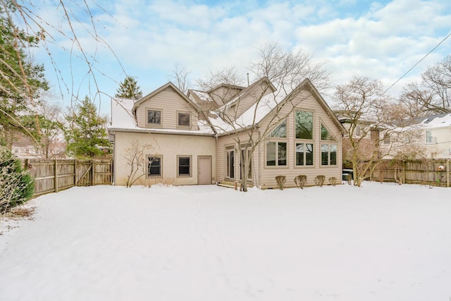 view of snow covered rear of property