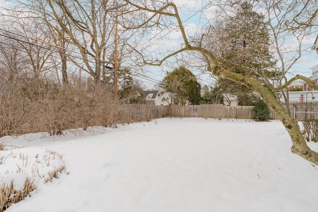 view of yard layered in snow