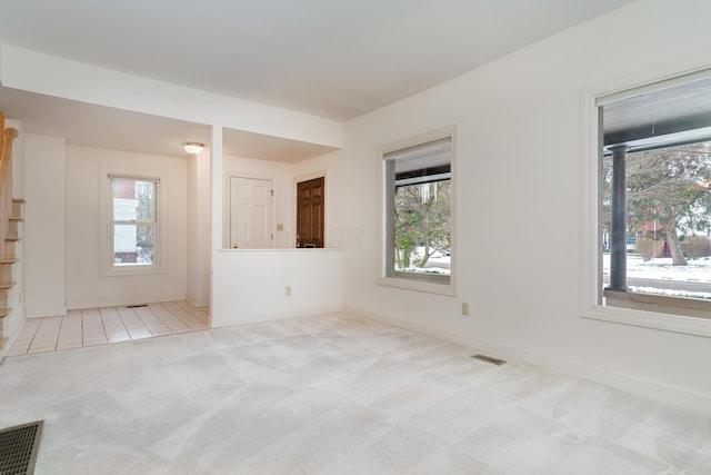 carpeted empty room featuring a healthy amount of sunlight